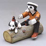 A boy with a puppy, a couple birds and a lady bug sitting on a log together
 by Marilyn Ray of Acoma