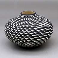 A black on white jar decorated with a spiral mesa geometric design
 by Paula Estevan of Acoma