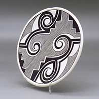 A black on white plate decorated with a fineline, Tularosa spiral , kiva step and geometric design, click or tap to see a larger version