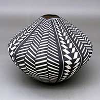 Click for a larger view A black on white seed pot with a squarish opening and decorated with a basketweave geometric design
by Sandra Victorino of Acoma