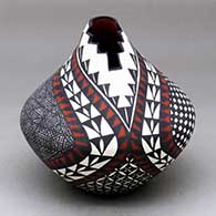 Click for a larger view A polychrome jar with a kiva step cut opening and decorated with a fineline, checkerboard, yucca leaf snowflake and geometric design
by Sandra Victorino of Acoma