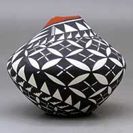 A polychrome jar with a kiva step cut opening and decorated with a yucca leaf snowflake and geometric design, click or tap to see a larger version