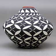 A polychrome jar with a kiva step cut opening and decorated with a yucca leaf snowflake and geometric design, click or tap to see a larger version