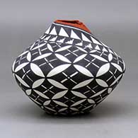 A polychrome jar with a kiva step cut opening and decorated with a yucca leaf snowflake and geometric design, click or tap to see a larger version