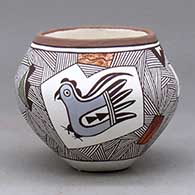 A small polychrome jar decorated with medallions enclosing a hummingbird, a parrot and a butterfly, surrounded by a fineline geometric design
 by Judy Lewis of Acoma