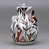 A small polychrome jar with a boy and cat perched on the shoulder and a bird on the rim and decorated with a lizard and geometric design, click or tap to see a larger version