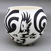 A black on white jar decorated with an eagle and geometric design
 by Eric Lewis of Acoma