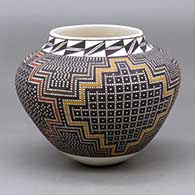 A small polychrome jar decorated with a tiny square geometric design
 by Frederica Antonio of Acoma