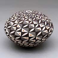A polychrome seed pot decorated with a spiraling fineline and geometric design
 by Sharon Lewis of Acoma