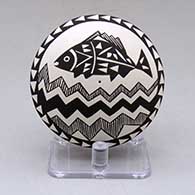 A black on white seed pot decorated above the shoulder with a fish, fineline and geometric design
 by Sharon Lewis of Acoma