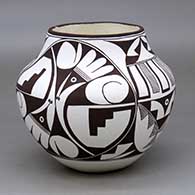 A black on white jar decorated with a four panel bird element, fineline and geometric design
 by Franklin Peters of Acoma