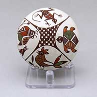 Click for a larger view A polychrome seed pot decorated with a turtle, bird, lizard, plant, checkerboard and geometric design
 by Diane Lewis of Acoma