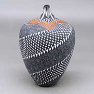 A polychrome tear drop jar decorated with a spiraling fineline, checkerboard and geometric design
 by Sandra Victorino of Acoma