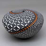 A polychrome seed pot decorated with a pumpkin seed snowflake, fineline, checkerboard and geometric design
 by Sandra Victorino of Acoma