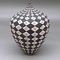 A tall polychrome tear drop jar decorated with a fineline, flower and spiraling geometric design
 by Sandra Victorino of Acoma
