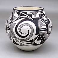 A black on white jar decorated with a four-panel Tularosa spiral, fineline, kiva step and geometric design
 by Franklin Peters of Acoma