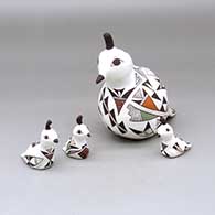 A polychrome quail mother with three chicks, all decorated with geometric design
 by Judy Lewis of Acoma