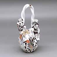 A polychrome wedding vase with a twisted handle, two children, a puppy, a kitten, lady bug and decorated with a lizard, butterfly and geometric design
 by Judy Lewis of Acoma
