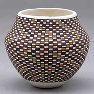 A small polychrome jar decorated with a tiny square geometric design
 by Frederica Antonio of Acoma