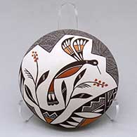 Click for a larger view A polychrome seed pot decorated on top with a hummingbird, flower, fineline and geometric design
by Rebecca Lucario of Acoma