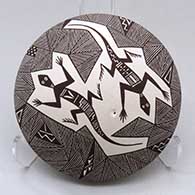 A black on white seed pot decorated on top with a lizard, fineline and geometric design
 by Rebecca Lucario of Acoma