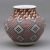 A small polychrome jar decorated with a four-panel spiraling geometric design built of tiny colored squares
 by Frederica Antonio of Acoma