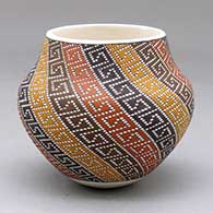 A small polychrome jar decorated with a four-panel spiraling geometric design built of tiny colored squares
 by Frederica Antonio of Acoma