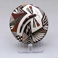 A polychrome seed pot with appliques, and painted with a dragonfly, lady bug, fineline and geometric design
 by Carolyn Concho of Acoma