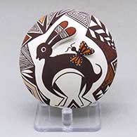 A polychrome seed pot with appliques, and painted with a rabbit, butterfly, lady bug, fineline and geometric design
 by Carolyn Concho of Acoma