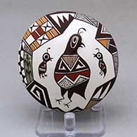 A polychrome seed pot with appliques, and painted with a quail, lady bug, corn stalk and geometric design
 by Carolyn Concho of Acoma