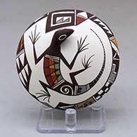 A polychrome seed pot with appliques, and painted with a lizard and geometric design
 by Carolyn Concho of Acoma
