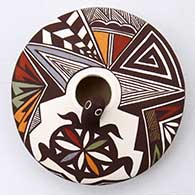A polychrome seed pot with appliques, and painted with a turtle, lady bug, fineline and geometric design
 by Carolyn Concho of Acoma