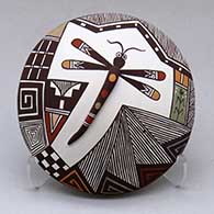 A polychrome seed pot with appliques and painted with a dragonfly, lady bug, fineline and geometric design
 by Carolyn Concho of Acoma