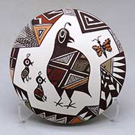 A polychrome seed pot with appliques and painted with a quail, butterfly, lady bug, fineline and geometric design
 by Carolyn Concho of Acoma
