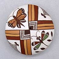 A polychrome seed pot decorated on top with a dragonfly, butterfly and geometric design
 by Diane Lewis of Acoma
