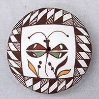 A polychrome seed pot decorated on top with a dragonfly, plant and geometric design
 by Diane Lewis of Acoma