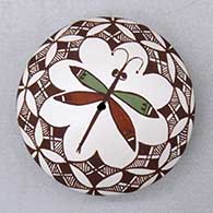 A polychrome seed pot decorated on top with a dragonfly, yucca leaf snowflake, fineline and geometric design
 by Diane Lewis of Acoma