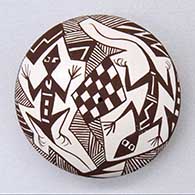 A black on white seed pot decorated on top with a lizard, fineline, checkerboard and geometric design
 by Diane Lewis of Acoma