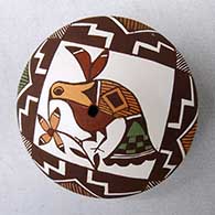 A polychrome seed pot decorated on top with a hummingbird, flower, fineline and geometric design
 by Diane Lewis of Acoma