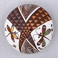 A polychrome seed pot decorated on top with a dragonfly, fineline and geometric design
 by Diane Lewis of Acoma