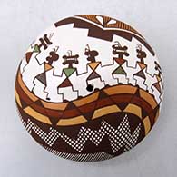 A polychrome seed pot decorated on top with a line of Mimbres dancers, fineline and geometric design
 by Diane Lewis of Acoma