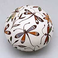 A polychrome seed pot decorated with multiple dragonflies, plants flowers and geometric design
 by Diane Lewis of Acoma