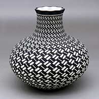 A black on white jar with a short neck, a pie crust rim and decorated with a herringbone basket weave geometric design
 by Paula Estevan of Acoma