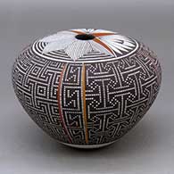 A polychrome seed pot decorated with a four panel tiny squares geometric design around the body and a fineline and geometric design on the top
 by Frederica Antonio of Acoma