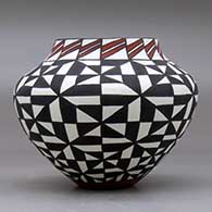 A polychrome jar decorated with a geometric design, click or tap to see a larger version