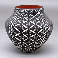 Click for a larger view A polychrome jar decorated with a four panel fineline, pumpkin seed snowflake and geometric design
 by Sandra Victorino of Acoma