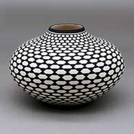 A black on white jar decorated with a Keres butterfly geometric design
 by Paula Estevan of Acoma