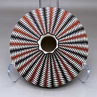 A polychrome low shouldered jar with a short neck and pie crust rim, decorated top and bottom with a spiral checkerboard geometric design
 by Paula Estevan of Acoma
