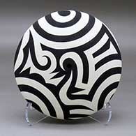 A black on white seed pot decorated with a three panel bird element, spiral and geometric design
 by Eric Lewis of Acoma