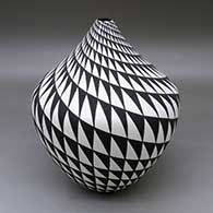 A large black on white jar decorated with a spiral mesa geometric design
 by Sandra Victorino of Acoma